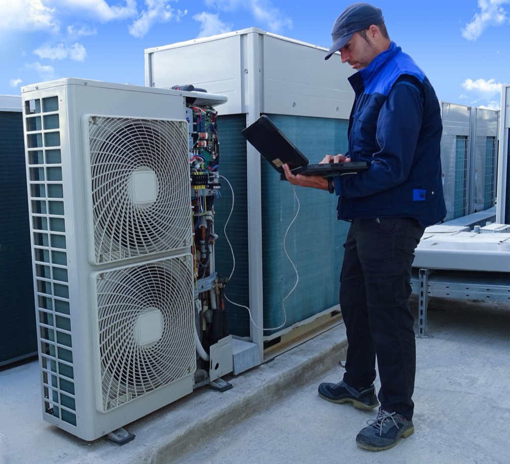 Raco technician commissioning rooftop HVAC units
