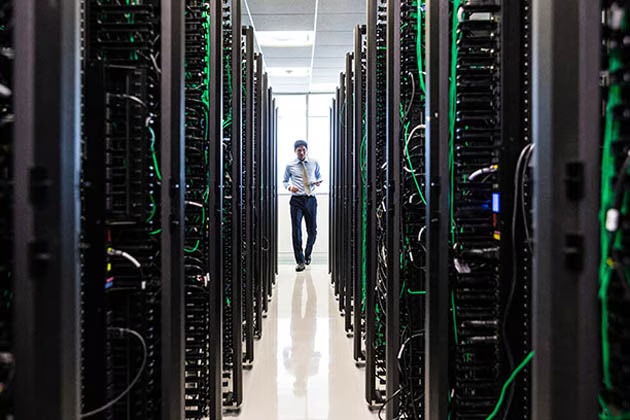 Engineer inspecting data center racks